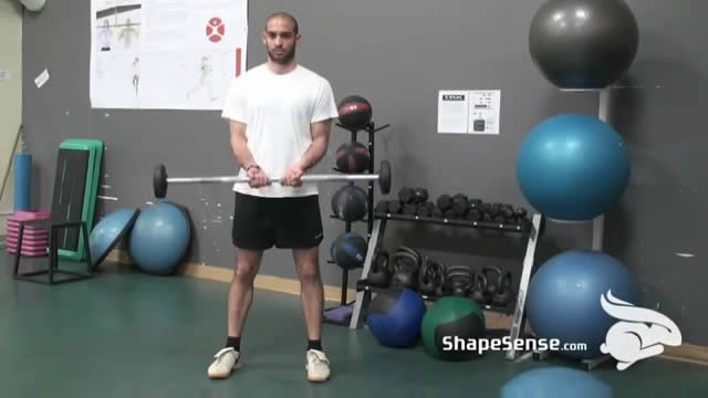 An image of a man performing the close grip barbell curl exercise.