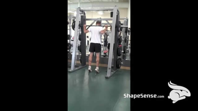An image of a man performing the smith machine calf raise exercise.