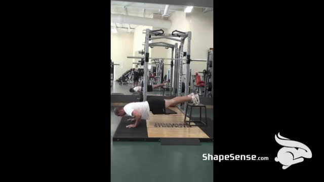 An image of a man performing the decline push up exercise.