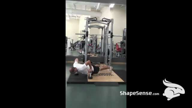 An image of a man performing the depth push up exercise.