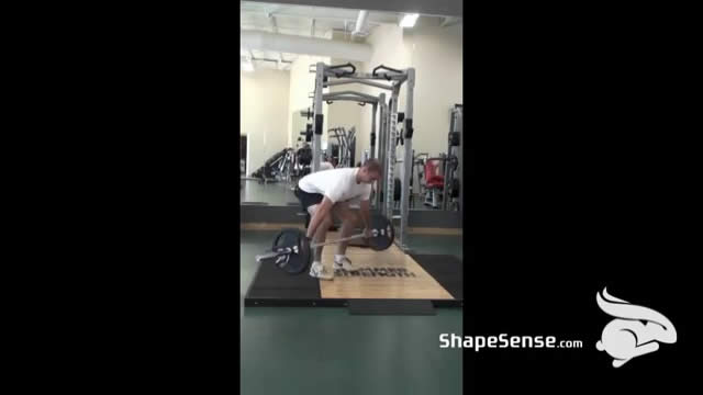 An image of a man performing the snatch grip deadlift exercise.