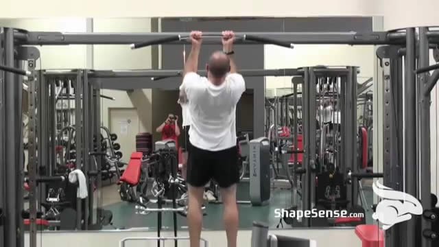 An image of a man performing the chin up exercise.