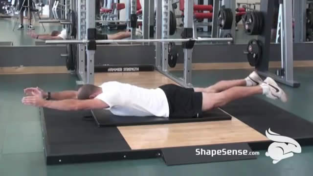 An image of a man performing the bilateral superman exercise.