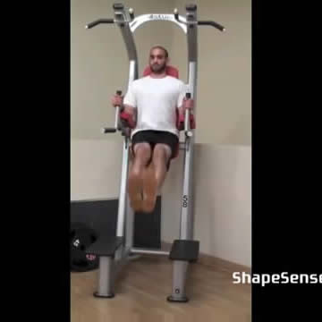 An image of a man performing the roman chair leg raise exercise.