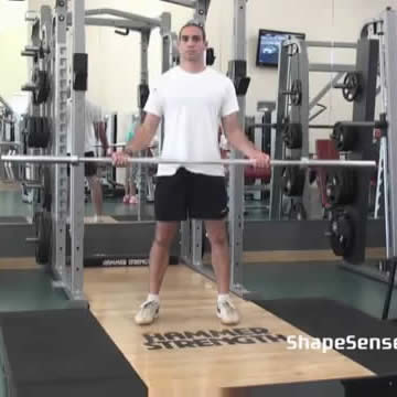 An image of a man performing the wide grip barbell curl exercise.