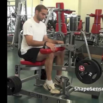 An image of a man performing the seated calf raise exercise.