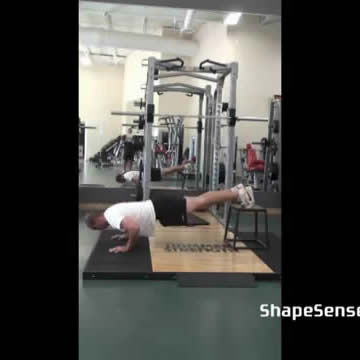 An image of a man performing the decline push up exercise.