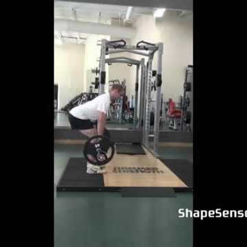 An image of a man performing the romanian deadlift exercise.