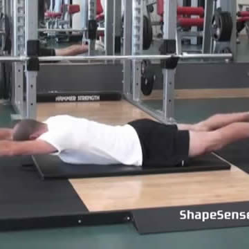 An image of a man performing the bilateral superman exercise.