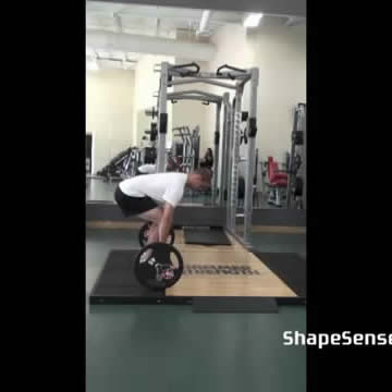 An image of a man performing the deadlift exercise.