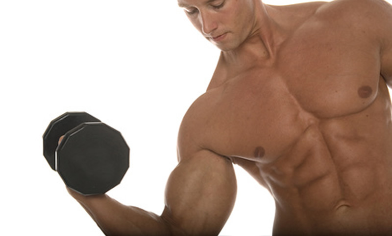 A fit man curling a dumbbell.