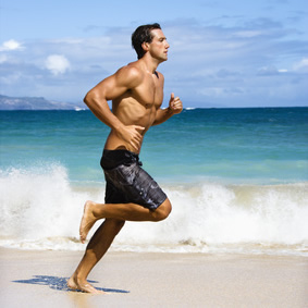 A man running on the beach.