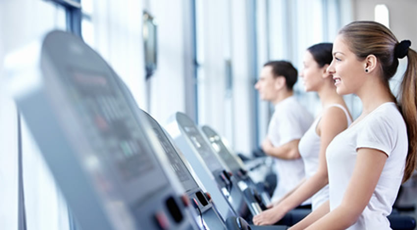 A woman walking on a treadmill.