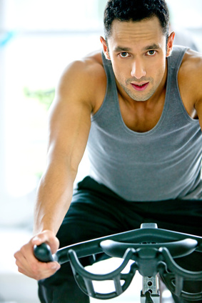 a man riding a stationary bike to get in shape