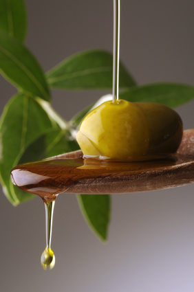 olive oil dripping off a spoon