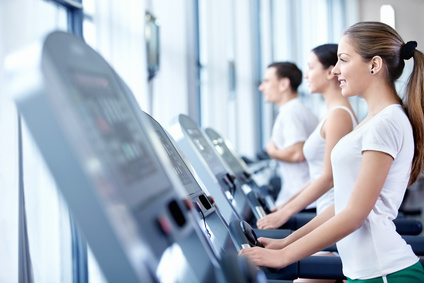a woman walking on a treadmill